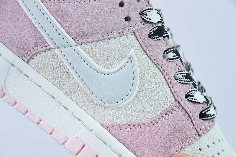 the nike dunk low appears in pink and grey suede dv3054-600